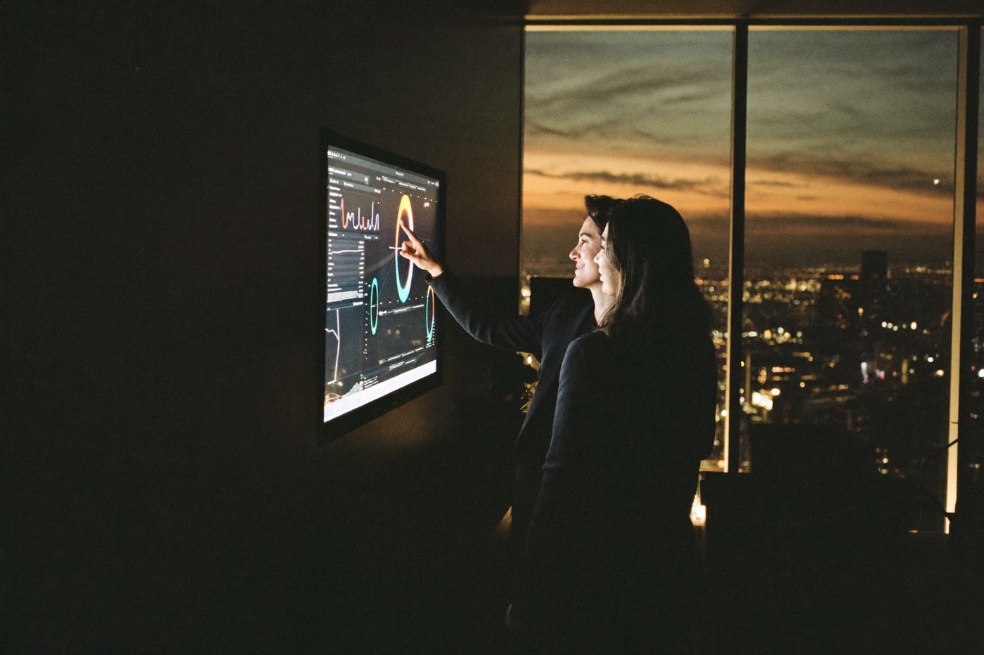 Two colleagues reviewing an operations dashboard together